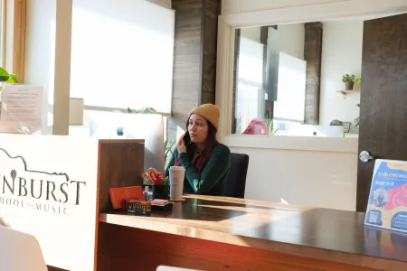 A Sunburst team member takes a call at the front desk