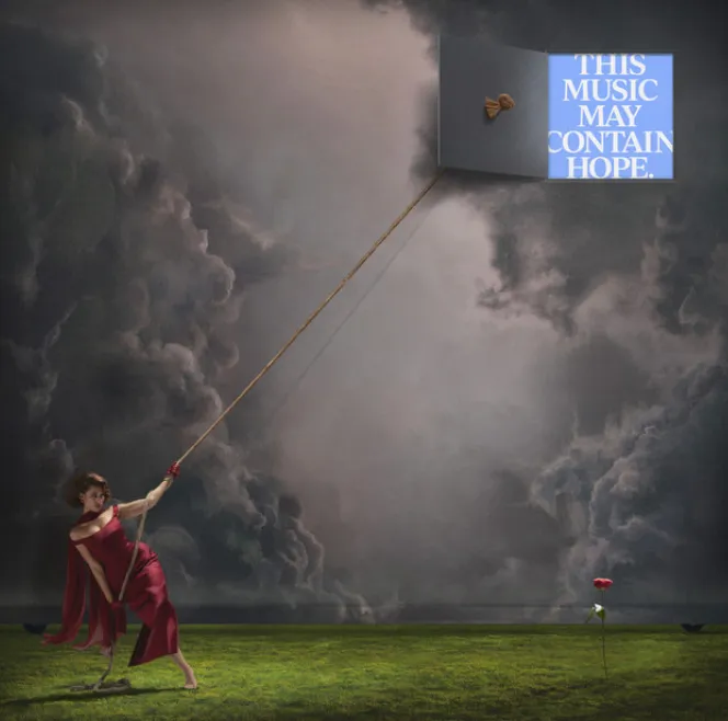 Album cover for This Music May Contain Hope: a woman in a red dress pulls on a rope tied to a door in a stormy sky, with a single red rose in the grass below