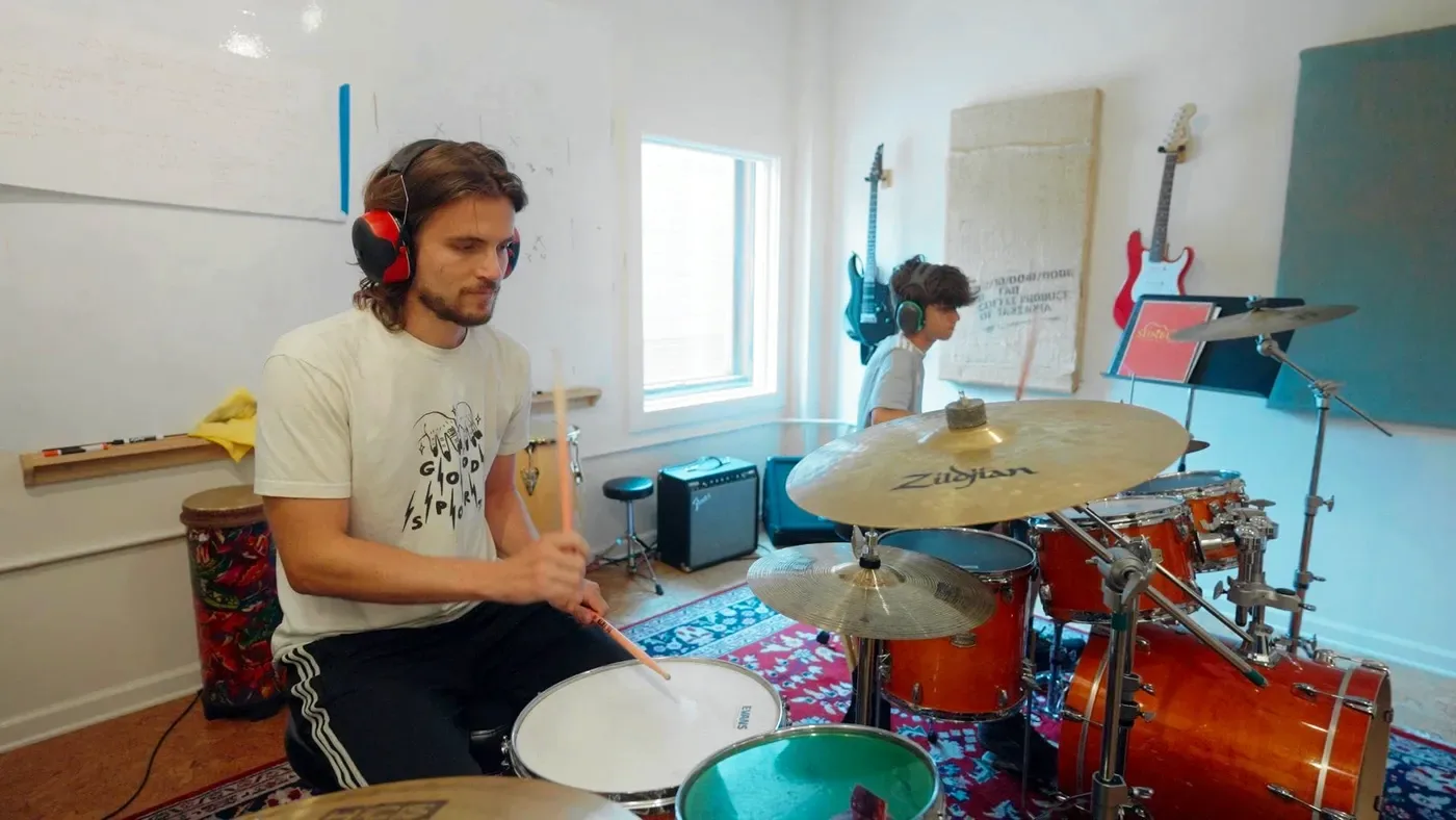 Two drummers lock in together on a pair of kits in a Sunburst drum room