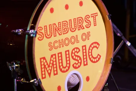 The Sunburst School of Music bass drum on stage