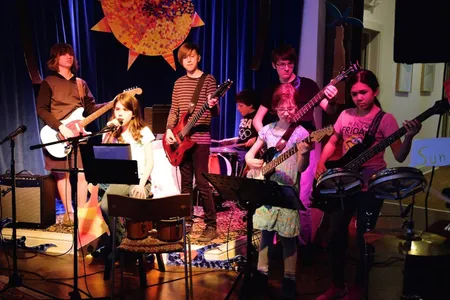 A kids' band performs at a Sunburst group program concert